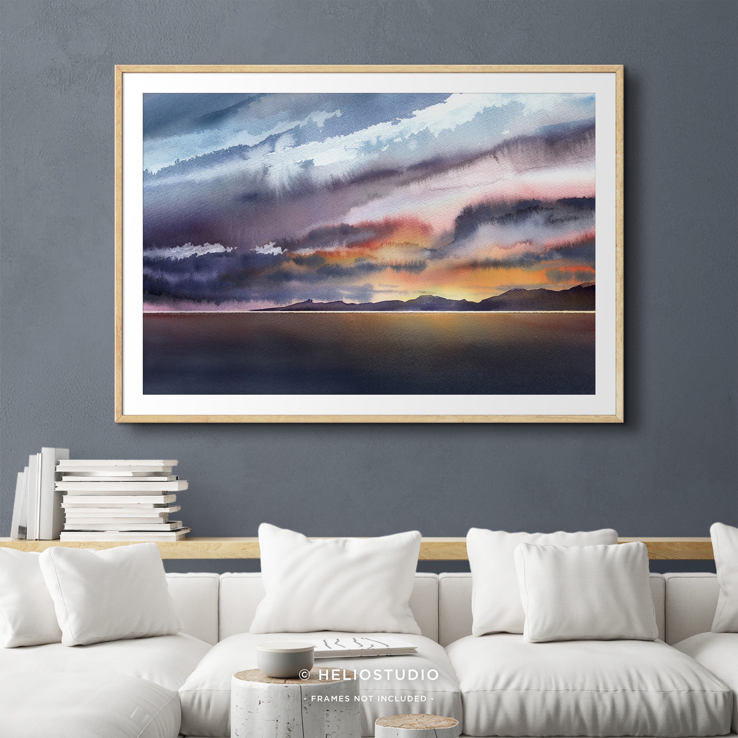 colourful watercolour sunset in wooden frame with white mount hanging in comfortable living room